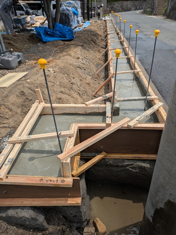 施工中<br />木をすべて伐採・撤去して基礎工事をしています。<br />フェンスの下に化粧ブロックを設置していきます。